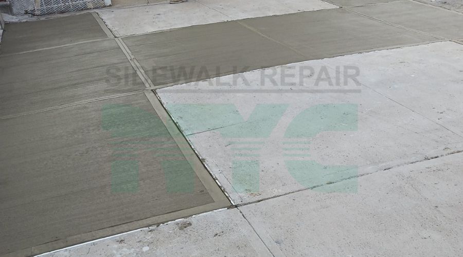 New York City sidewalk with visible cracks and uneven surfaces, highlighting common violations and maintenance tips for property owners.