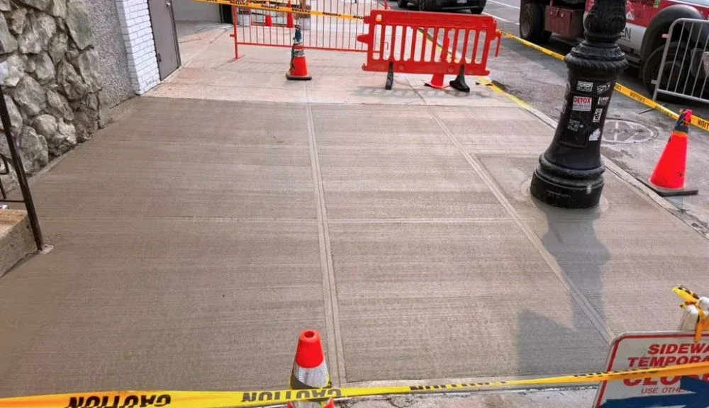 close-up of repaired sidewalk joint and crack area after concrete restoration in harlem