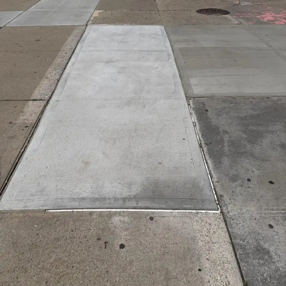 close-up of repaired sidewalk joint and crack area after concrete restoration in harlem