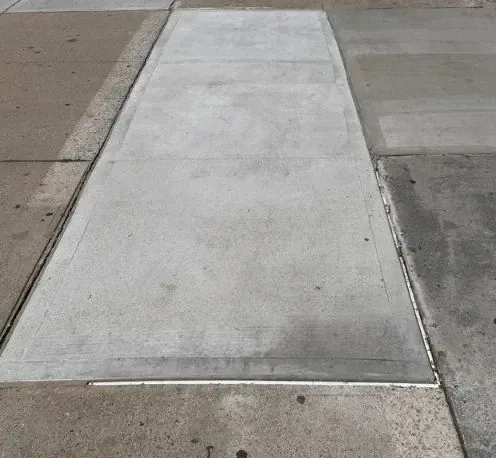 level new concrete sidewalk after dot violation removal at 646 malcolm x blvd in harlem manhattan